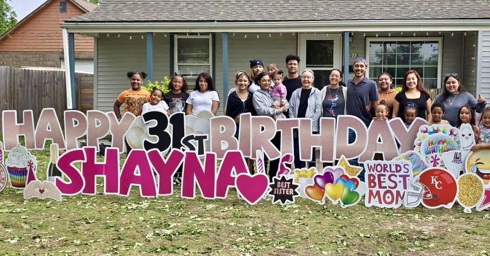 neighbors enjoying yard sign during celebration